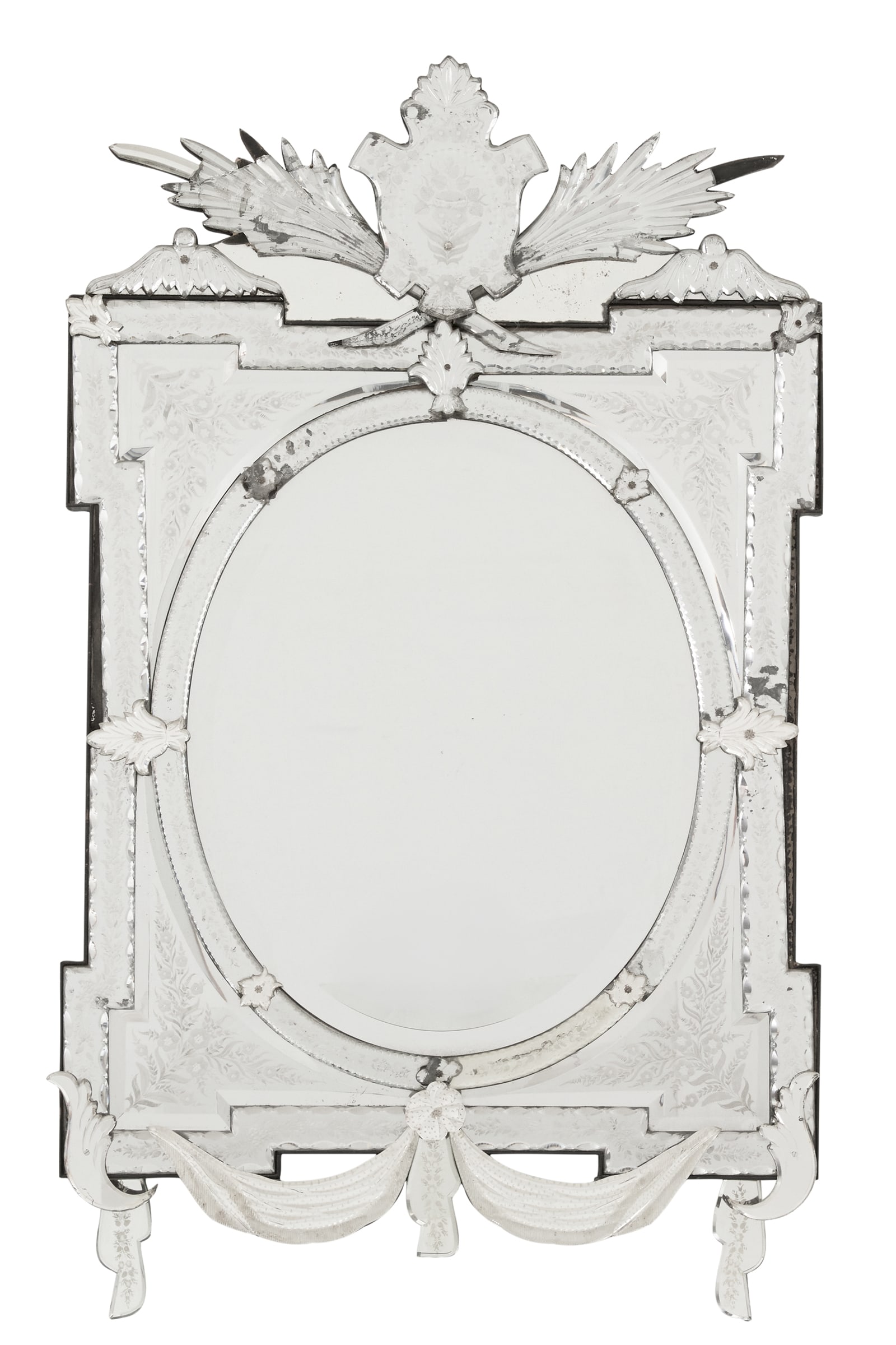 Italian Venetian Engraved Glass Mirror: Italian Venetian Beveled and Engraved Glass Mirror mid-20th century, the crest engraved with flowers and vines, the crossetted surround notch-cut and engraved with running floral vines, set with an ov