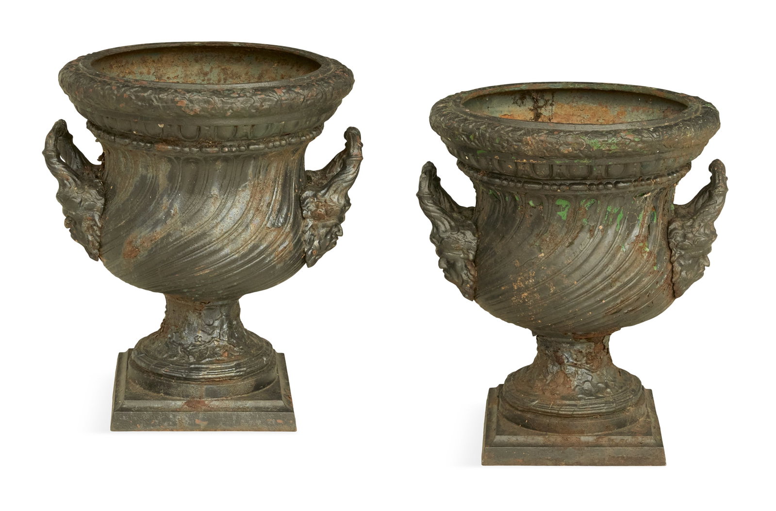 Pair of Unusual French Cast-Iron Garden Urns: Pair of Unusual French Cast-Iron Garden Urns fourth quarter 19th century, each with an oak-leaf-molded rim, over an inverted bell-form body molded with swirled fluting and set with handles with bold m