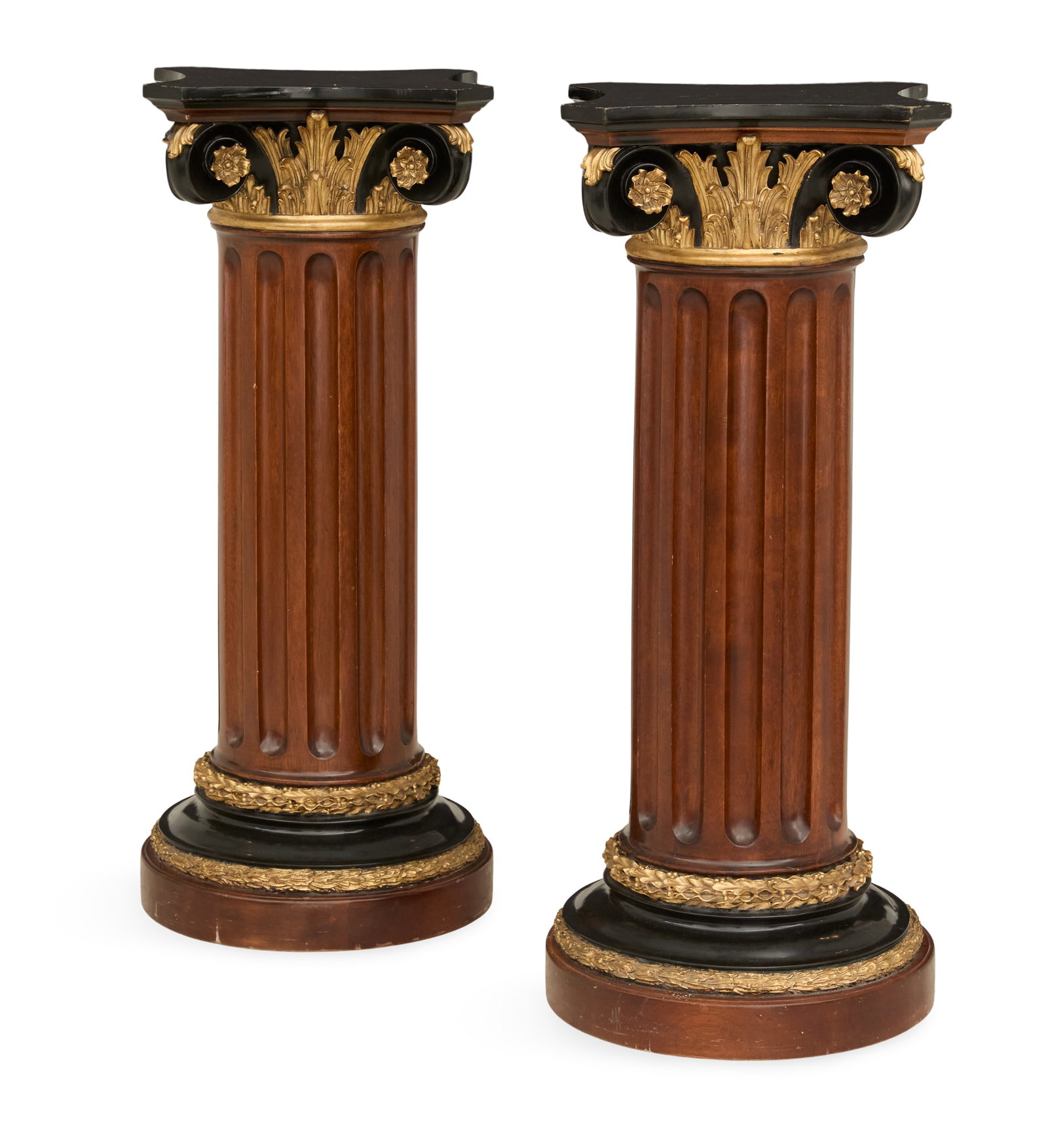 Pair of Neoclassical Carved Wooden Pedestals: Pair of Neoclassical Carved Wooden Pedestals mid-20th century, the ebonized tops over column-form standards with parcel-gilt and ebonized Ionic capitals atop fluted mahogany stands, the bases with ebo