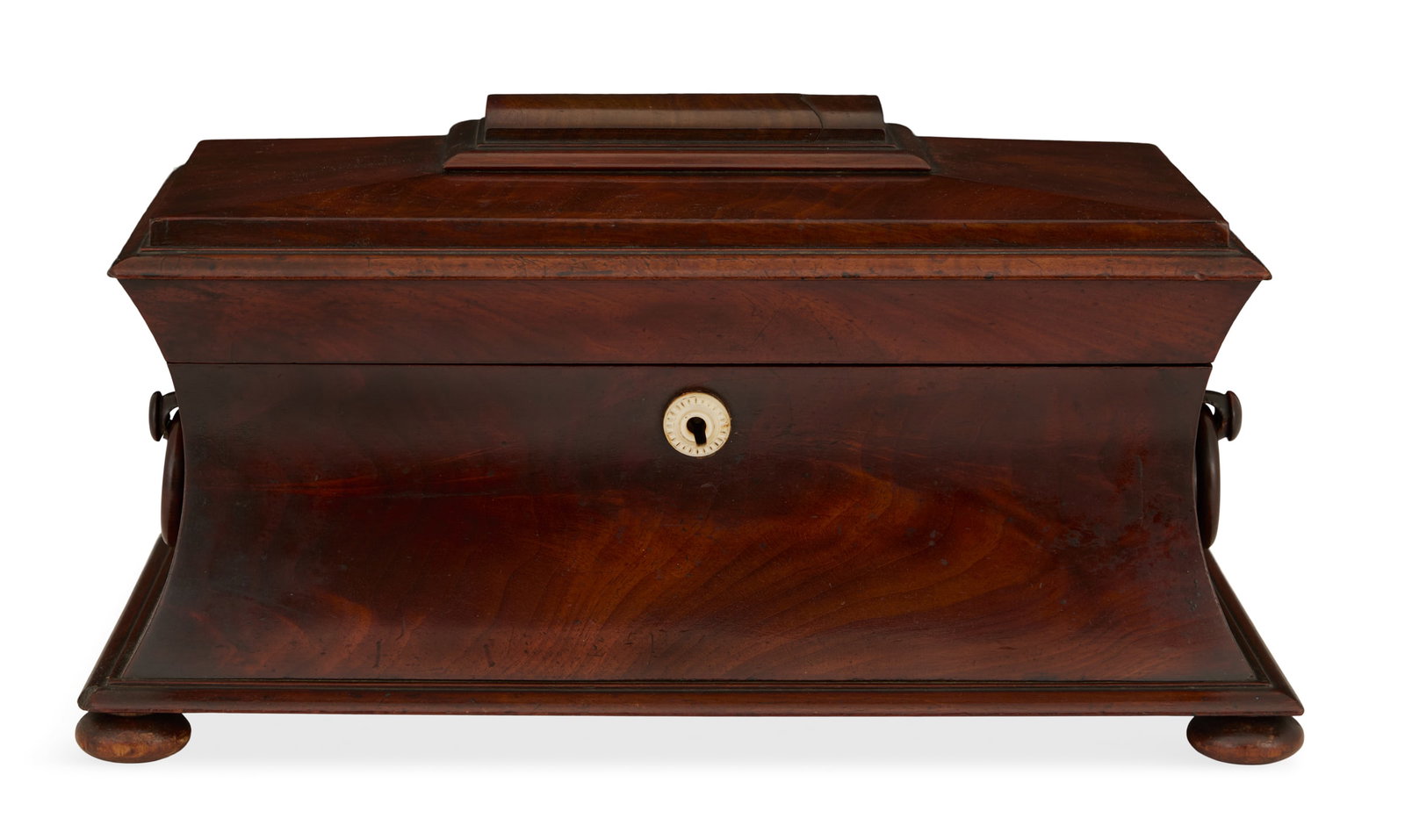 William IV Mahogany Tea Caddy: William IV Mahogany Tea Caddy ca. 1830, the caddy with incurvate sides set with mahogany ring pulls and a mother-of-pearl escutcheon, the hinged cover with a pulvinated panel, opening to reveal an