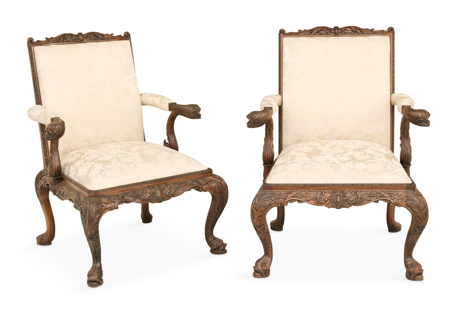 Pair of Georgian-Style Mahogany Library Chairs: Pair of Georgian-Style Mahogany Library Chairs 20th century, in the manner of William Kent, each with a carved frame, padded back and slip seat, carved dolphin hand grips and carved skirt with cabriol