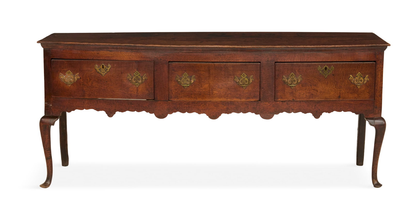 English Oak Server: English Oak Server 18th century, the rectangular top above a case fitted with three drawers over a scalloped apron, raised on cabriole legs ending in pad feet. h. 31", w. 73", d. 19"