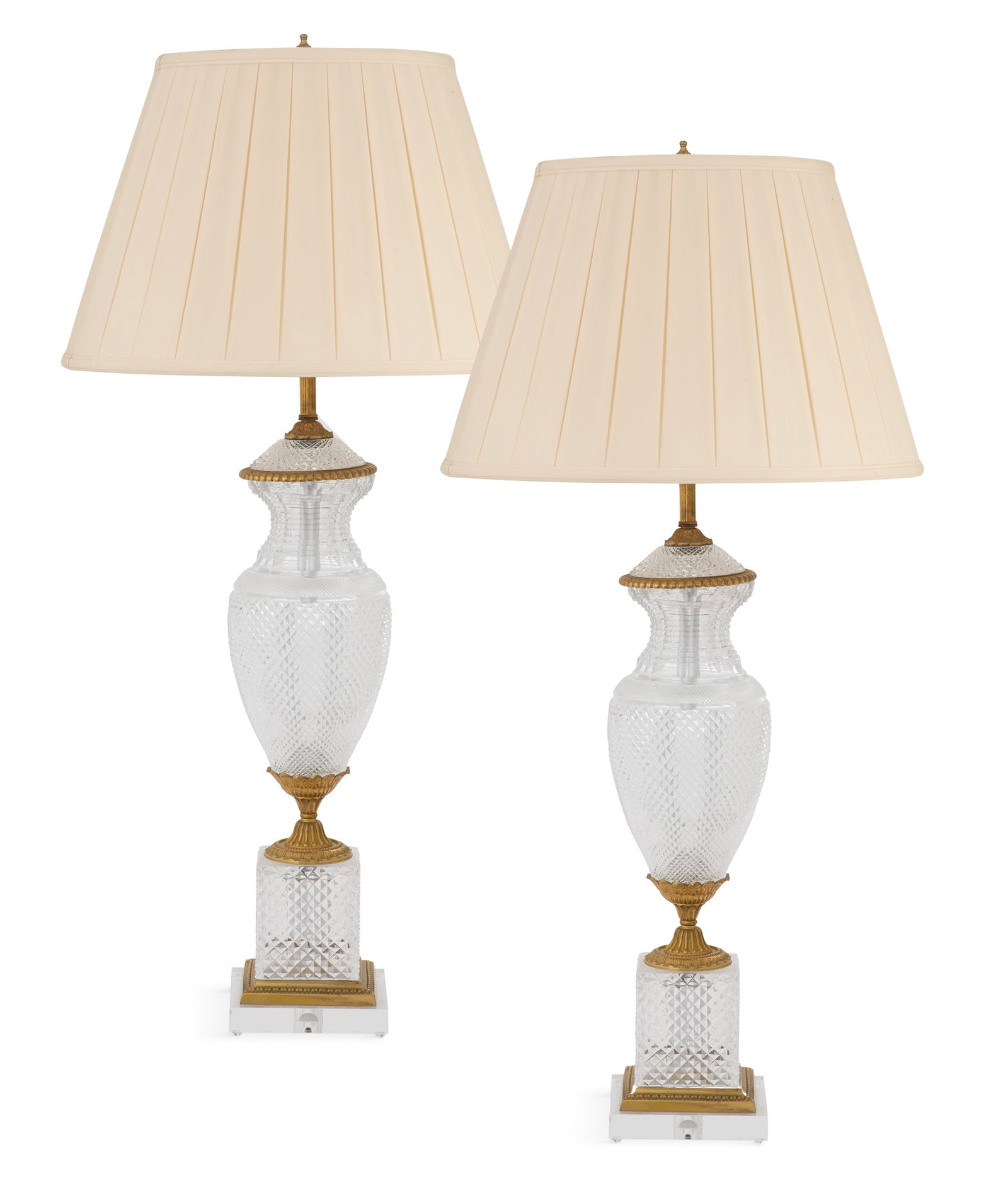 Pair of Cut-Glass and Gilt-Bronze Table Lamps: Pair of French Cut-Glass and Gilt-Bronze Table Lamps mid-20th century, in the Baccarat taste, the diamond-cut vasiform bodies on fluted leaf-molded cone-form mounts, raised on matching bases with bron