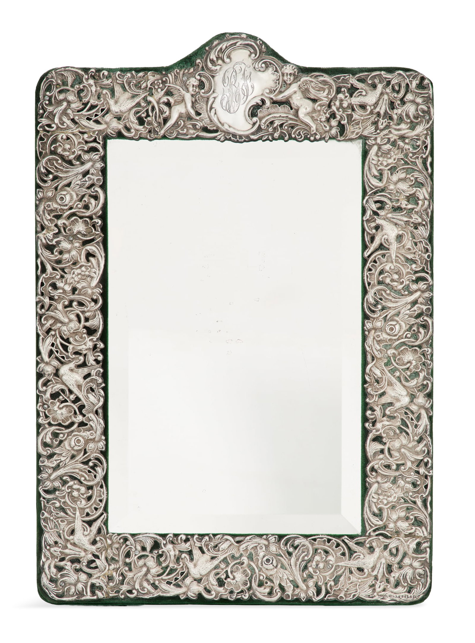 American Sterling Silver Vanity Mirror: American Sterling Silver Vanity Mirror first quarter 20th century, Dominick & Haff, New York, New York, the rounded rectangular frame embossed with openwork flowers and birds among scrolls, with rococ