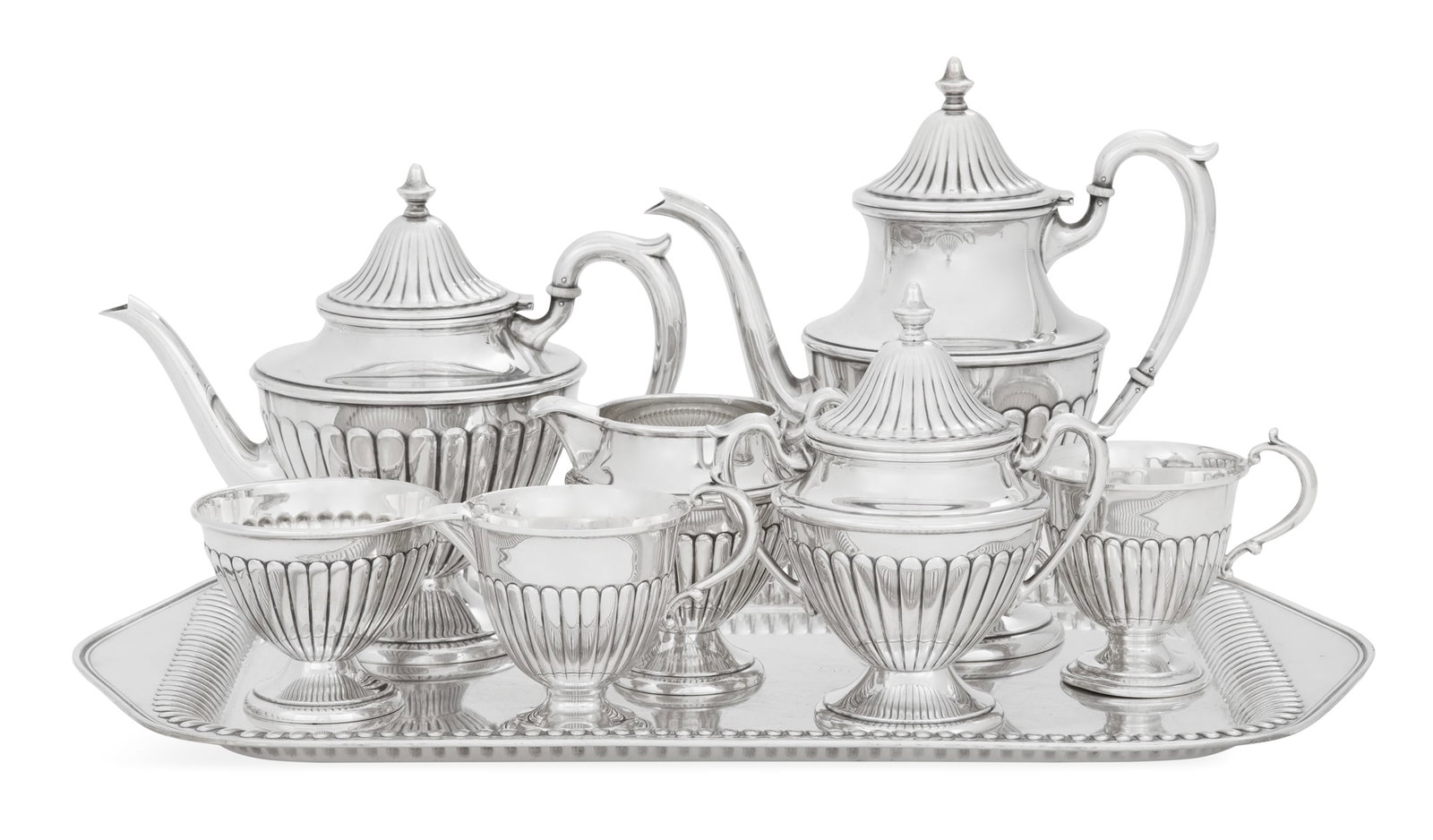 American Sterling Silver Tea Set: American Sterling Silver Tea Set mid-20th century, Dunkirk Silversmiths, Meriden, Connecticut, including: a coffeepot, h. 10", l. 10", dia. 5-1/4"; a teapot, h. 8-1/2", l. 10-1/4", dia. 5-3/4"; a