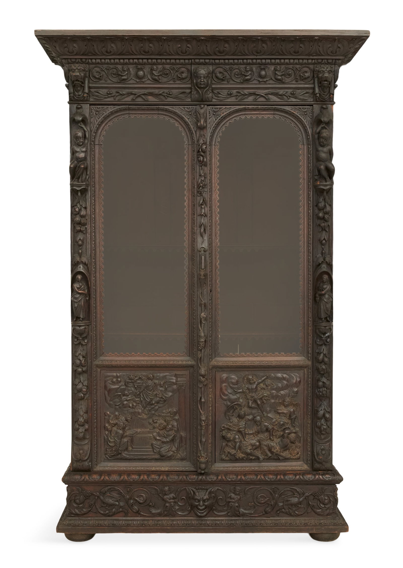 Continental Carved Oak Bookcase: Continental Carved Oak Bookcase 19th century, in the Renaissance taste, profusely carved with a pair of arched and glazed doors, flanked by columns with allegorical scenes of figures and animals, the 