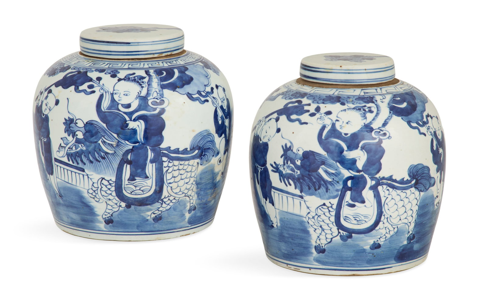 Pair of Chinese Export Covered Ginger Jars: Pair of Chinese Export Porcelain Covered Ginger Jars late 19th century, the blue-and-white jars decorated with children riding qilin, the covers with painted trees. h. 9", dia. 6-3/4"