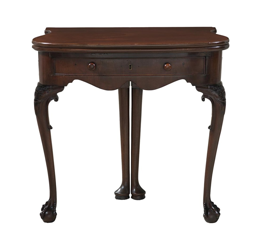 Edwardian Mahogany Games Table: Edwardian Mahogany Games Table early 20th century, in the Georgian taste, the shaped and rounded top hinged and opening to gaming piece wells and a baize-lined interior, raised on cabriole legs headed