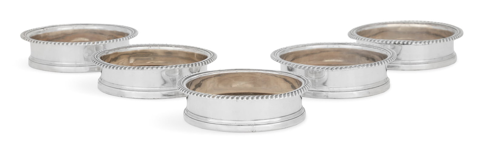 Five Regency Old Sheffield Plate Wine Coasters: Set of Five Regency Old Sheffield Plate Wine Coasters first quarter 19th century, each with a turned wooden base and fused silver plate side with gadrooned rim, the center with silver boss engraved wi