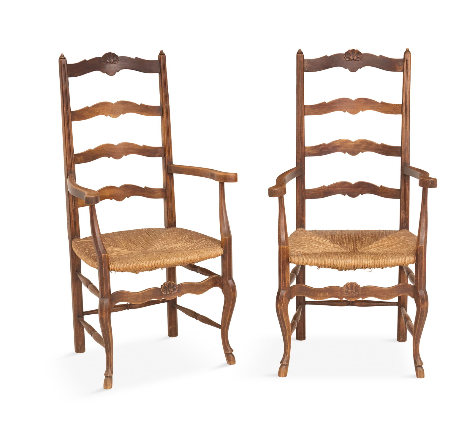 Pair of French Ash Wood Ladderback Armchairs: Pair of French Ash Wood Ladderback Armchairs 19th century, each with a tall splayed back and shaped splats, curved arms, and a woven rush seat, raised on cabriole legs joined by a carved front stretch