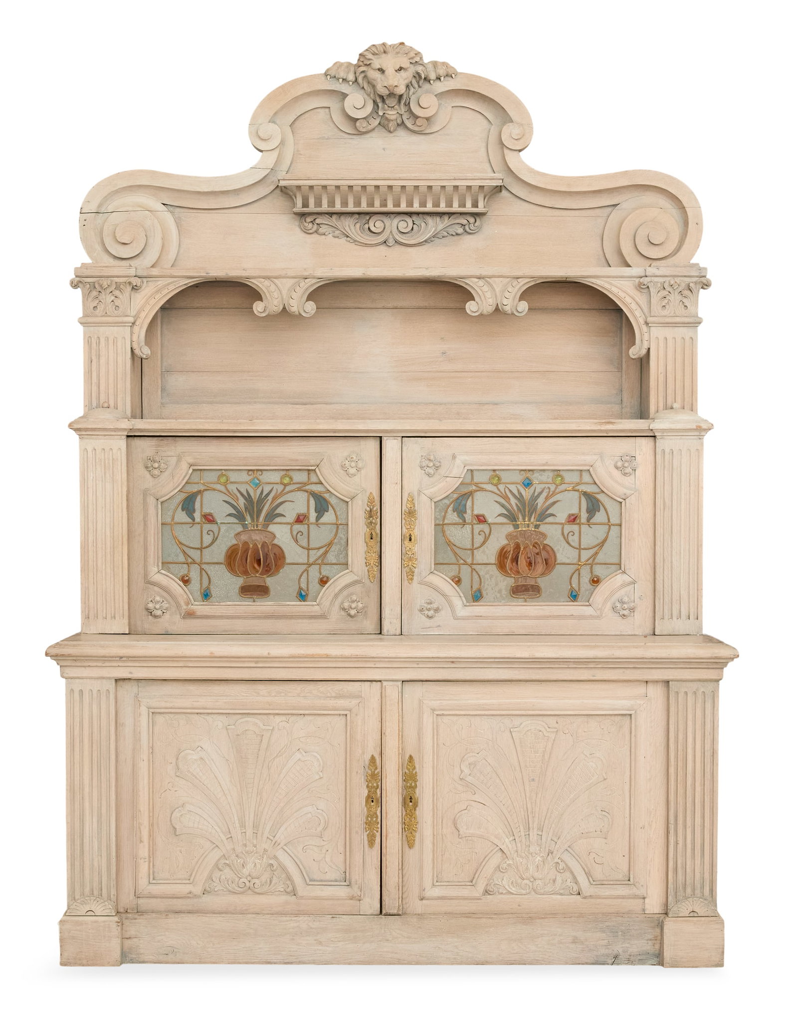 Continental Pickled Oak Breakfront: Continental Pickled Oak Breakfront early 20th century, the large arched crest centered by a carved lion's masque, over an arched opening and a pair of stained glass doors, the base with a pair of