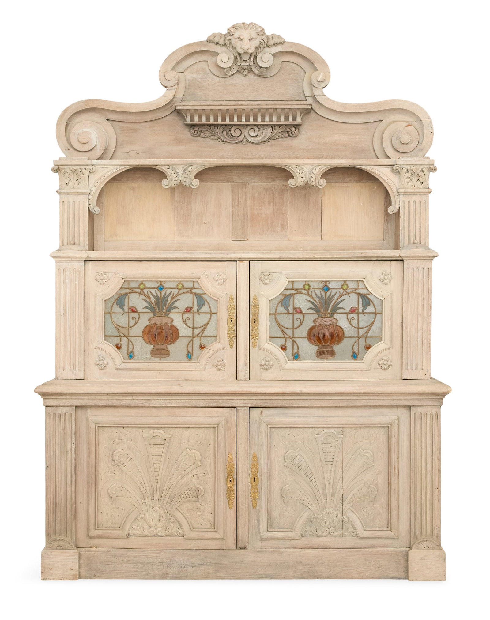 Continental Pickled Oak Breakfront: Continental Pickled Oak Breakfront early 20th century, the large arched crest centered by a carved lion's masque, over an arched opening and a pair of stained glass doors, the base with a pair of
