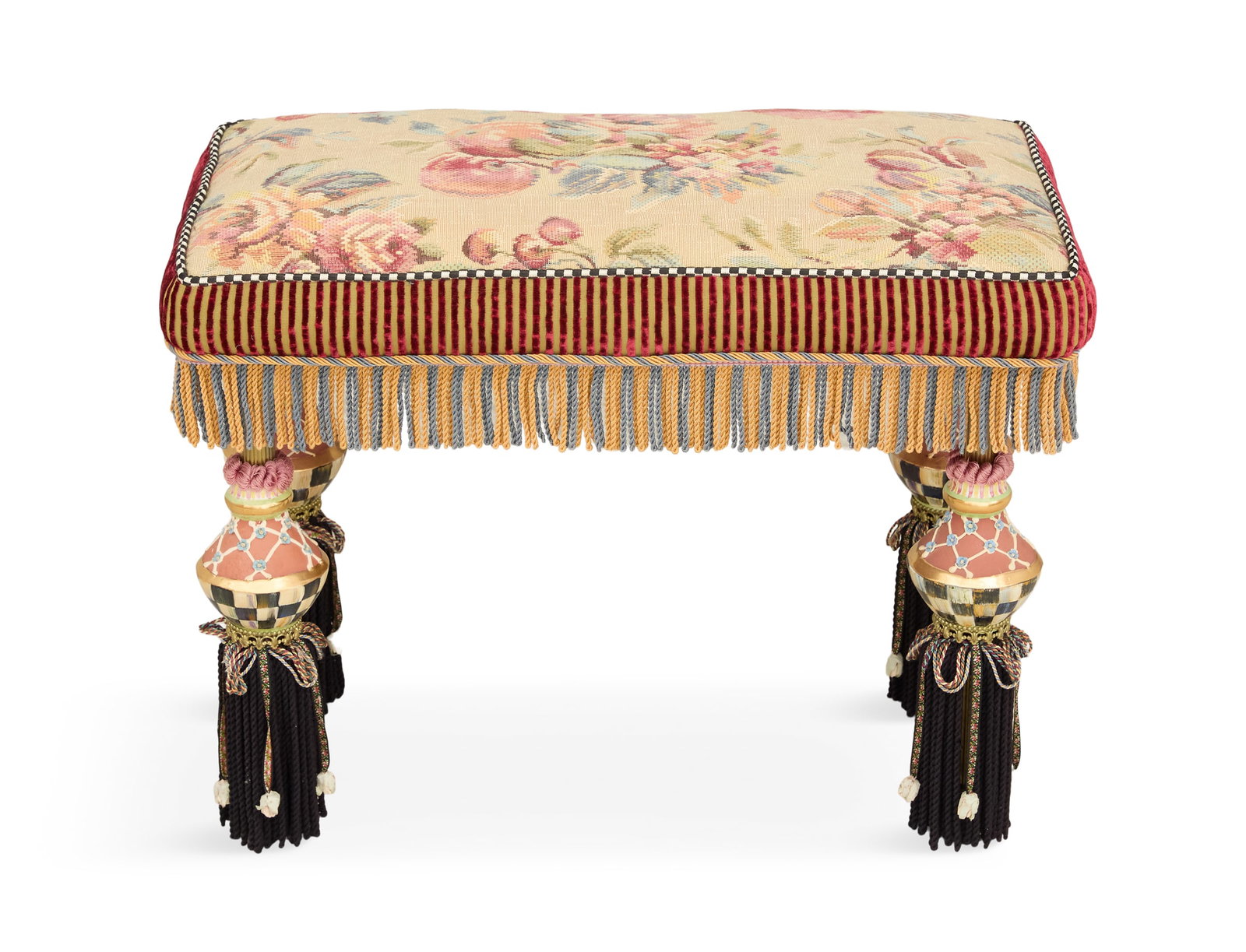 MacKenzie-Childs Polychrome Ottoman: MacKenzie-Childs Polychrome Ottoman the floral padded seat trimmed with long fringe and raised on bulbous legs. h. 18-1/2", w. 24", d. 14"