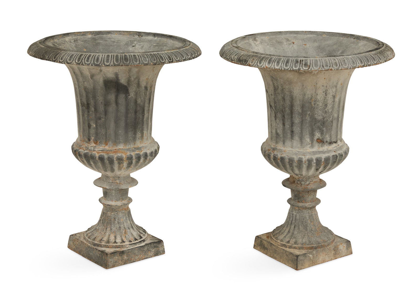 Pair of Cast-Iron Garden Urns: Pair of Cast-Iron Garden Urns in the neoclassical taste, the egg-and-dart rims over fluted bodies, raised on tapered bases. h. 24", dia. 18"