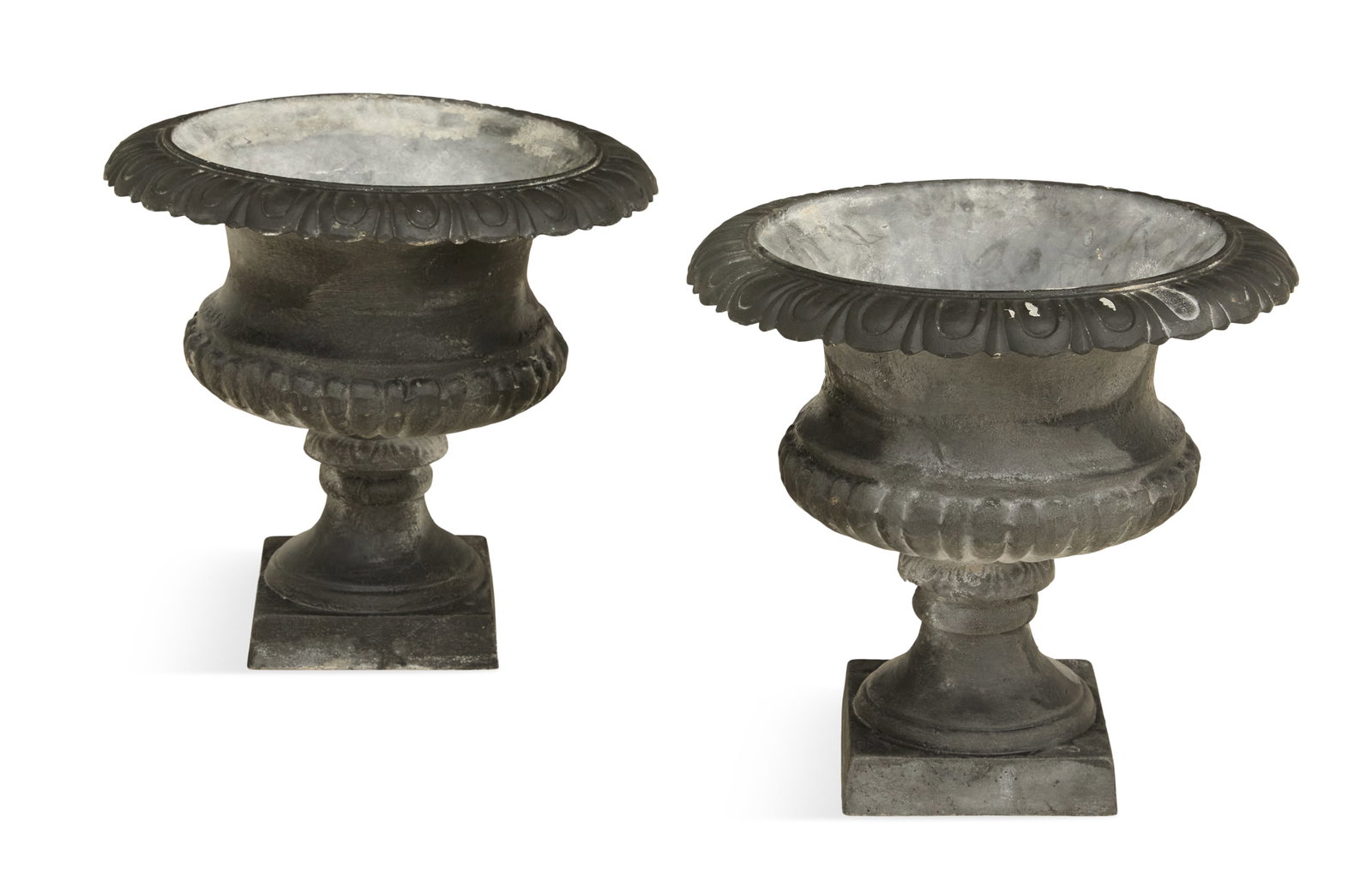 Pair of Cast-Iron Urns in the Neoclassical Taste: Pair of Cast-Iron Urns in the Neoclassical Taste contemporary, the egg-and-dart rims over reeded bodies, on tapered bases. h. 17-1/2", dia. 18"