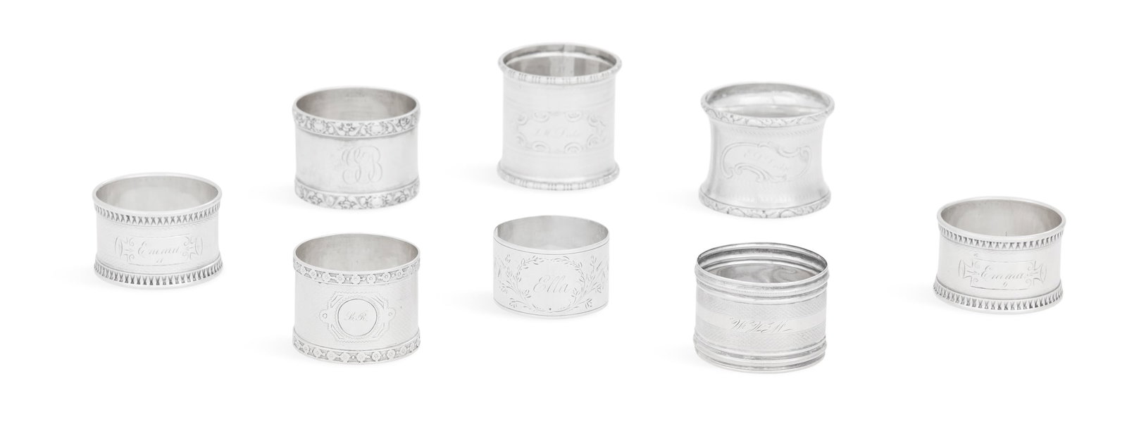 Eight American Silver Napkin Rings: Eight American Silver Napkin Rings late 19th/early 20th century, unmarked, all circular, including: a pair with lancet banded rim and guilloche decoration, inscribed "Emma / 9" and "Emma / 11", h. 1",