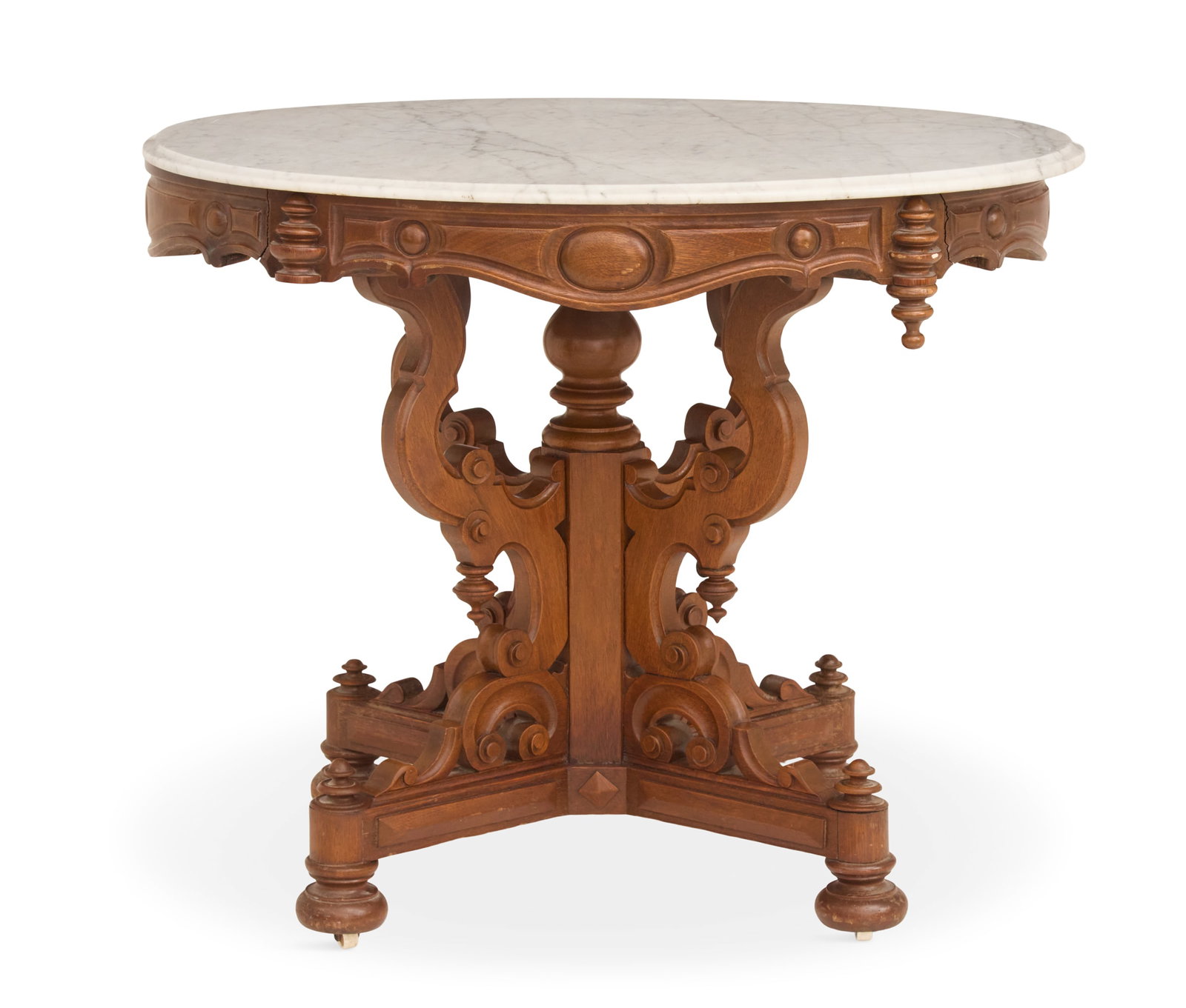 American Rococo Revival Marble-Top Center Table: American Rococo Revival Mahogany and Marble-Top Center Table third quarter 19th century, the oval white marble top over a carved frame with drop finials, supported by four shaped buttresses to a centr