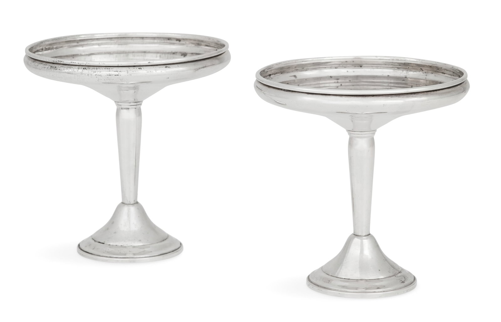 Pair of Sterling Silver Compotes: Pair of Sterling Silver Compotes mid-20th century, by Elgin Silversmith Co., Inc., New York, New York, each with a saucer-shaped bowl with slightly inverted rolled rim above a tapering standard and st