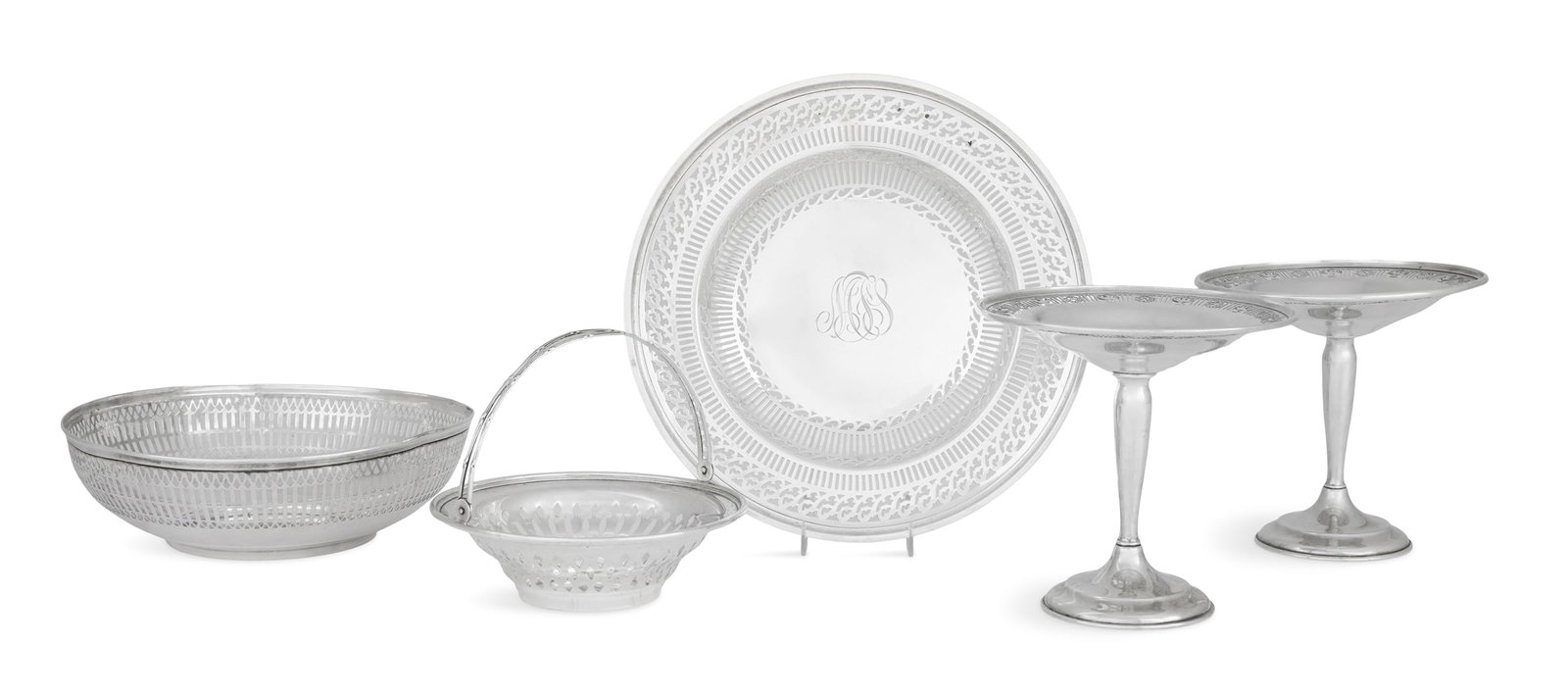 American Reticulated Sterling Silver Tableware: Five Pieces of American Reticulated Sterling Silver Tableware mid-20th century, including: a J. Wagner & Sons circular basket with reeded swing handle, monogrammed "MFB", dia. 6", h. 5" (with handle);