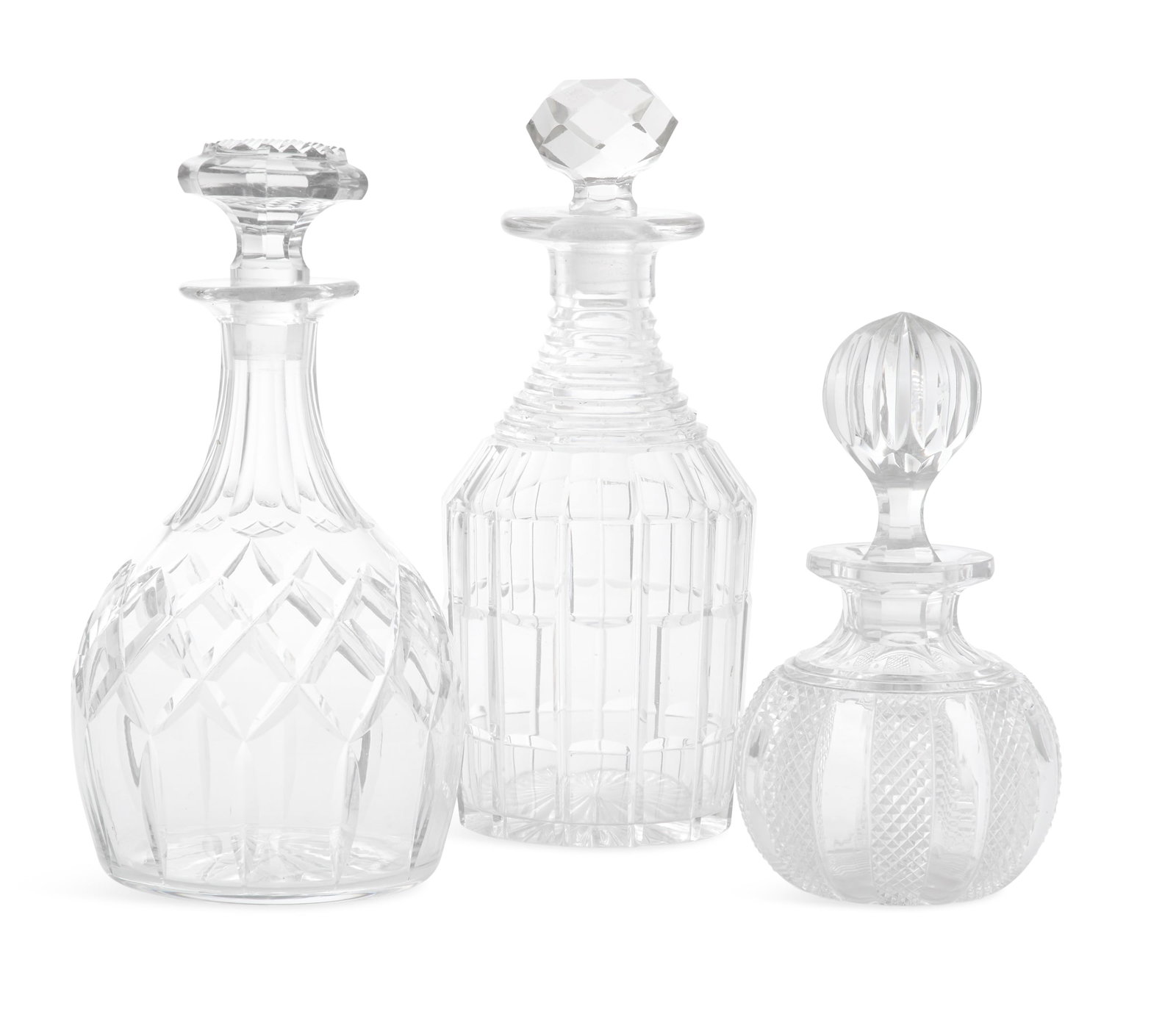 Collection of Three Cut-Glass Decanters: Collection of Three Cut-Glass Decanters 19th/20th century, the largest William IV example with block-cut sides, now with a faceted stopper, the middle example with a lattice-cut body, and the