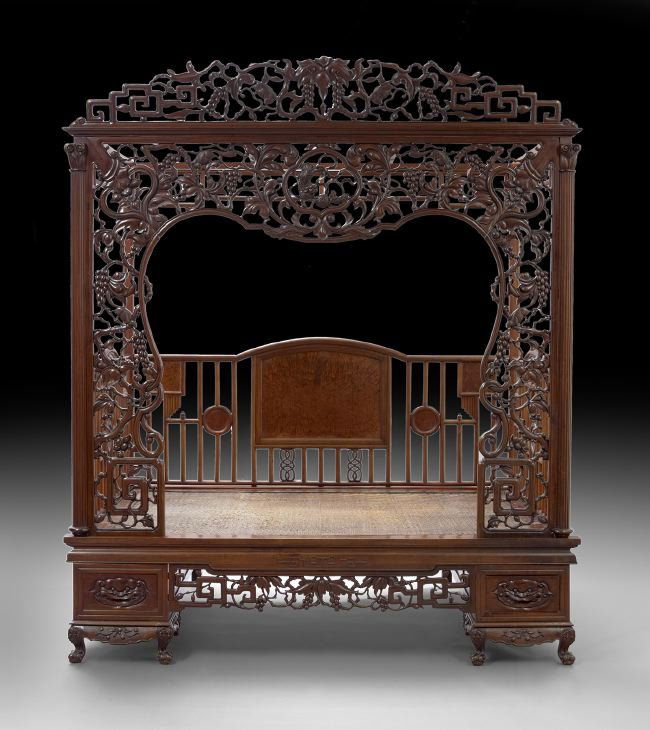 Chinese Rosewood Canopy Bed: Chinese Rosewood Canopy Bed, 19th century, finely carved and pierced with a squirrel and grape design and archaic scrolling, with lion's paw feet and two drawers carved with foo dog masks, h. 95-1/2",