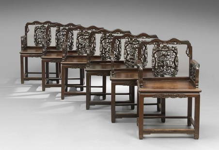 Suite of Six Chinese Rosewood Armchairs: Suite of Six Chinese Rosewood Armchairs, early 20th century, each with a shaped crest above a pierced and carved splat with animal patterns, joined by foliate-carved arms to the banded seat, raised