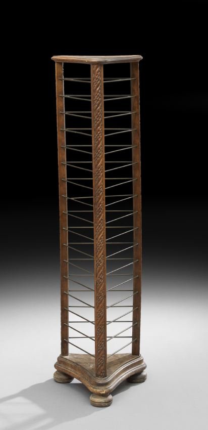 Provincial Mahogany Plate Rack: Provincial Mahogany Plate Rack, early 20th century, of concave tripartite form, the incised top above eighteen tri-form metal tiers to a molded base on bun feet, h. 50", dia. 13-1/2".