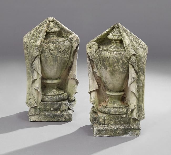 Pair of Carved Limestone Garden Ornaments: Pair of Carved Limestone Garden Ornaments, ca. 1900, of urn form and cloaked with drapery swags, h. 26".