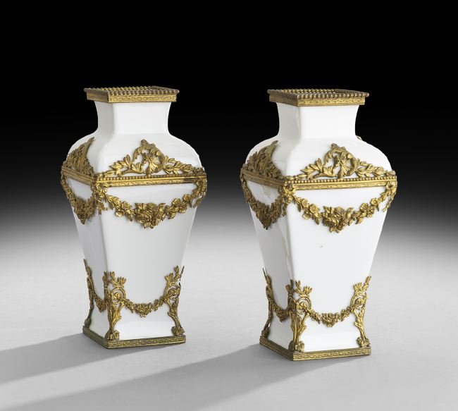 Pair of Limoges Blanc-de-Chine Porcelain Vases: Pair of P. M. de Mavaleix, Limoges, Blanc-de-Chine Porcelain Vases, 1908-1914, each of tapered square section and fitted with intricate ormolu mounts in the Louis XVI taste, each example marked "Franc