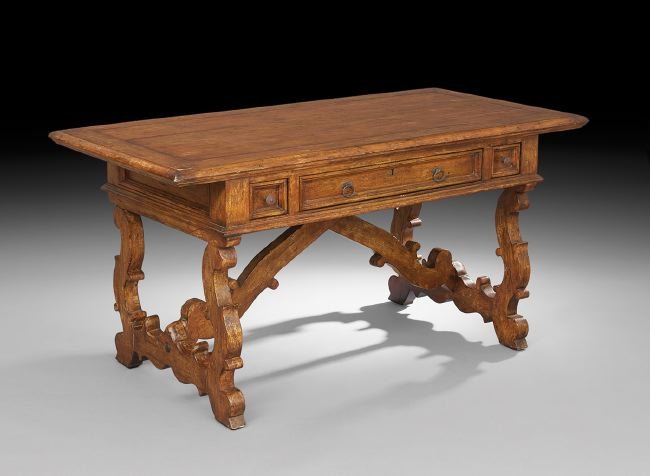 Spanish Provincial-Style Fruitwood Center Table: Spanish Provincial-Style Fruitwood Center Table, the banded rectangular top above a frieze fitted to one side with a central drawer flanked by small end drawers, raised on lyre-form end supports joine