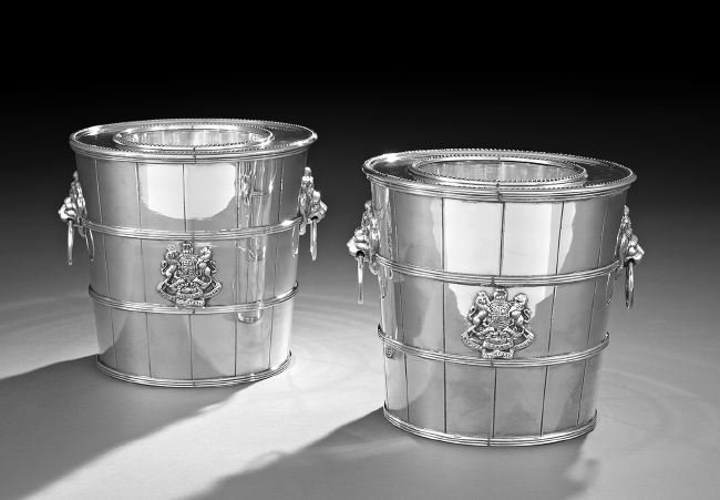 Pair of English Silverplate Wine Coolers: Pair of English Silverplate Wine Coolers, 20th century, each in the form of a staved bucket with reeded bands, with opposing ringed lion's masque handles and integral beaded collar and liner, the body