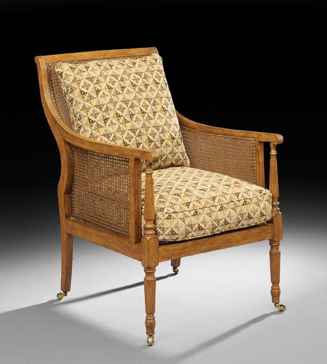 Regency-Style Fruitwood Armchair: Regency-Style Fruitwood Armchair, having a shaped and caned body with reeded details, now fitted with loose cushions, h. 38".