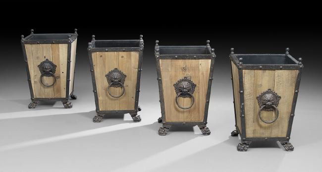 Four Neoclassical-Style Iron-Mounted Jardinieres: Group of Four Neoclassical-Style Iron-Mounted Pine Jardinieres, each with a tapering square body with wrought iron edging at the corners and cast iron leonine masques with ring handles on two sides, r