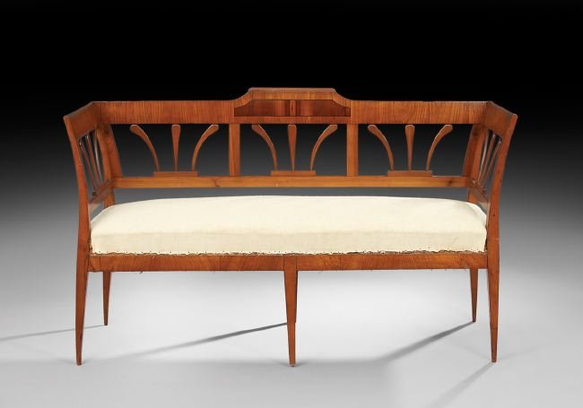 Continental Neoclassical-Style Fruitwood Settee: Continental Neoclassical-Style Fruitwood and Rosewood Settee, mid-19th century, the back with a raised center cornice over three panels with stylized plume splats, joined by outswept arms to the padde