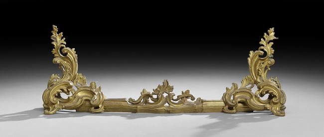 Belle Epoque Gilt-Bronze Fire Fender: Belle Epoque Gilt-Bronze Fire Fender, fourth quarter 19th century, in the Louis XV style, molded with pierced rocaille ornament, of adjustable length, molded with tool hooks on each side, h. 16", w. 4