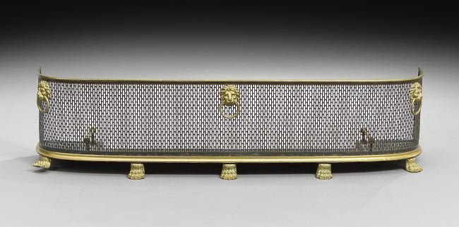 Regency Brass and Steel Fireplace Fender: Regency Brass and Steel Fireplace Fender, first quarter 19th century, with pierced steel sides set with brass lion's head ring pulls, set on brass paw feet, the "floor" retaining its tool rests, h. 14