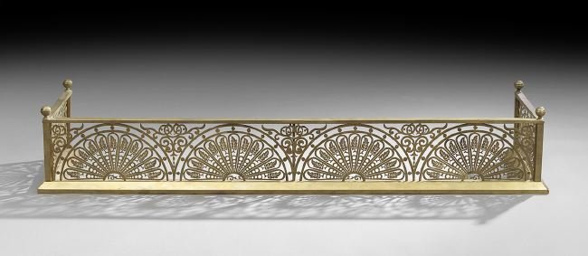 Brass Fire Fender of Aesthetic Inspiration: Pierced Brass Fire Fender of Aesthetic Inspiration, ca. 1900, pierced in fan-shaped patterns, and decorated with leaves and scrollwork, h. 10-1/2", w. 51-1/2", d. 16-1/4".
