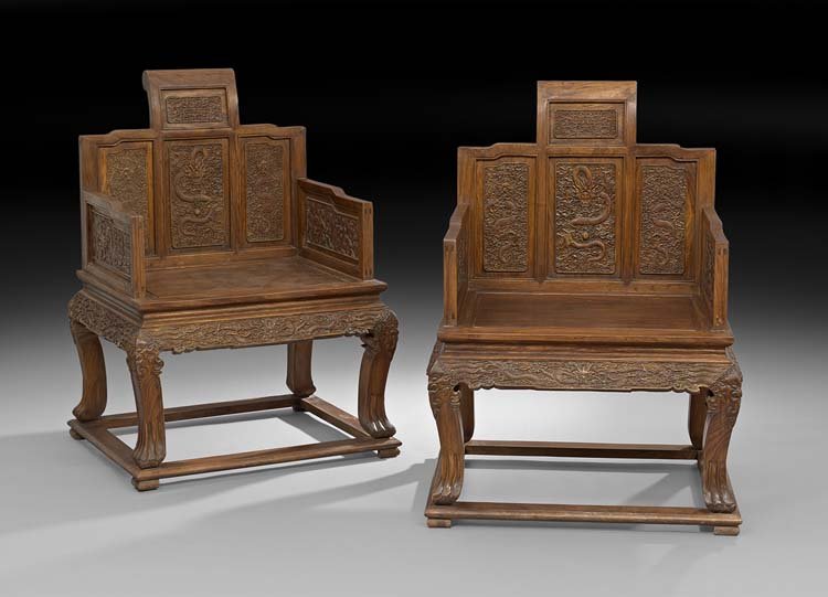 Pair of Chinese Huali Chairs: Pair of Chinese Huali Chairs, ca. 1950, the back, sides and aprons carved with dragons, pearls and clouds, with animal paw feet, h. 41", w. 27", d. 23".