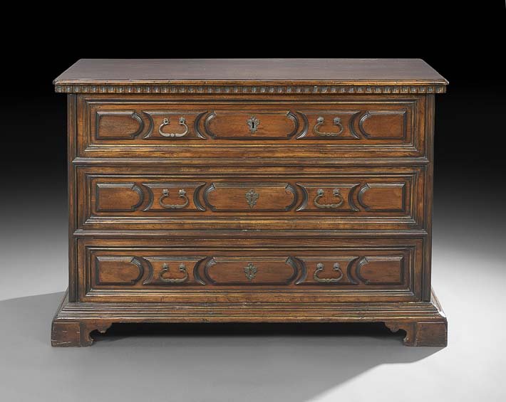 Provincial Italian-Style Fruitwood Commode: Provincial Italian-Style Fruitwood Commode, the rectangular top with a molded edge above a case fitted with three long drawers, all with molded panels, raised on bracket feet, h. 38-1/2", w. 53", d. 2