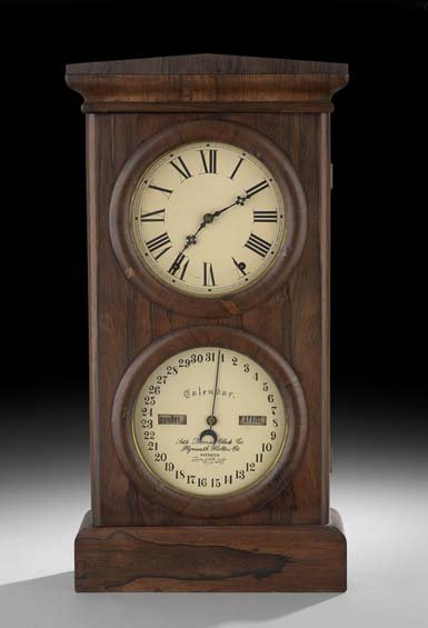 Seth Thomas Rosewood-Veneered Calendar Clock: Seth Thomas Rosewood-Veneered Double Dial Calendar Clock, ca. 1877, Connecticut, the Restauration case with a pitch pediment, a period label reading "The calendar was set at 1AM, Jan 1, 1877" inside t