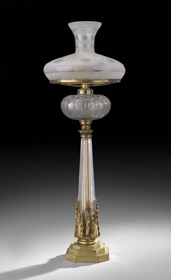 English Gilt-Bronze and Crystal Sinumbra Standard: English Gilt-Bronze and Crystal Sinumbra Standard, second quarter 19th century, now mounted as a banquet lamp with a cut glass kerosene font, with a stepped base supporting a tapered glass standard de
