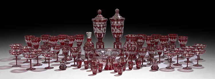 Collection of Bohemian-Style Ruby-Cased Glassware: Extensive Collection of Bohemian-Style Ruby-Cased Blown Glassware with Engraved Decoration, including a pair of covered sweetmeat jars engraved with deer, castles and rococo cartouches, h. 16-1/2", di