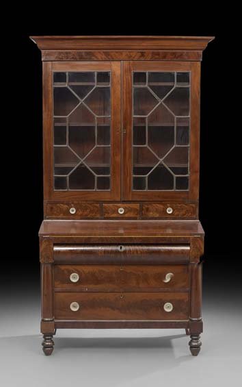 American Classical Mahogany Secretary Bookcase: American Classical Mahogany Secretary Bookcase, second quarter 19th century, the upper section with a projecting cornice over a pair of mullioned doors with a band of drawers below, the base with a fo
