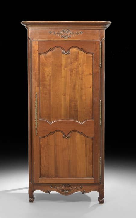 Provincial Louis XV-Style Fruitwood Cabinet: Provincial Louis XV-Style Fruitwood Cabinet, the molded rounded rectangular cornice above a case fitted with a single bi-paneled door, raised above a shaped apron on scrolled toes, h. 78-1/2", w. 38",