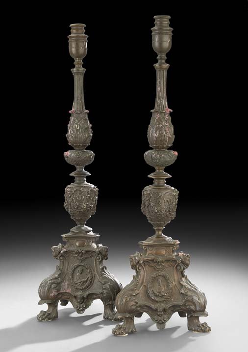 Pair of Italian Bronze Altar Sticks: Pair of Italian Bronze Altar Sticks in the Baroque Style, fourth quarter 19th century, of tripartite form, on paw feet, decorated with winged angel heads, swags of flowers and molded acanthus leaves, 