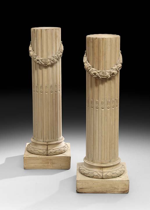 Pair of Louis XVI-Style Beechwood Pedestals: Pair of French Beechwood Pedestals in the Louis XVI Taste, early 20th century, each modeled as a fluted and stop-fluted column draped with floral garlands, on a stepped base, h. 43", w. 15", d. 15".