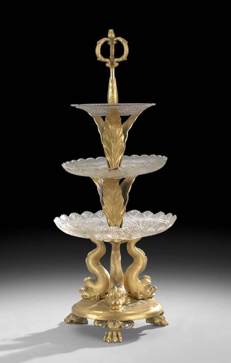 Napoleon III Bronze and Glass Dessert Stand: Napoleon III Bronze Dore and Glass Etagere-Form Dessert Stand, third quarter 19th century, with classical dolphins supporting the lower tier and molded water leaves supporting the upper two tiers, the