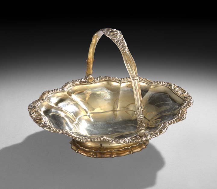 George IV Gilt Old Sheffield Plate Cake Basket: George IV Gilt Old Sheffield Plate Cake Basket, second quarter 19th century, of lobed oval form, with gadrooned rocaille rim and molded swing handle en suite, raised on a serpentine-lobed oval foot ri