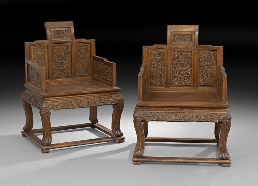Pair of Chinese HuangHuaLi Chairs: Pair of Chinese HuangHuaLi Chairs, ca. 1950, the back, sides and aprons carved with dragons, pearls and clouds, with animal paw feet, h. 41", w. 27", d. 23".