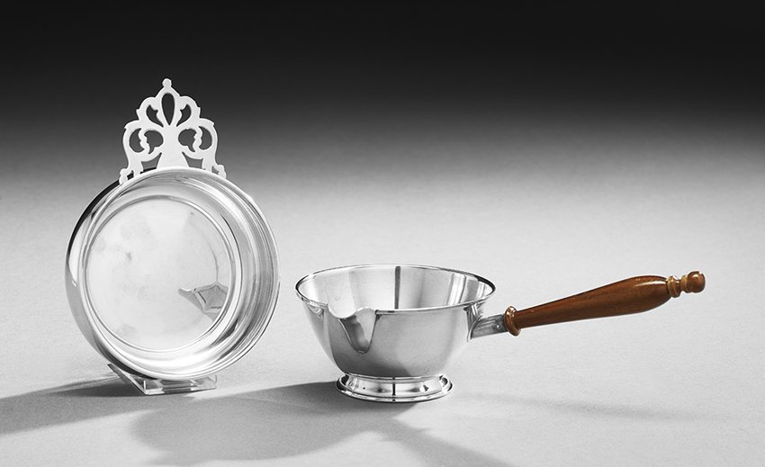 Two Pieces of American Silver Small Tableware: Two Pieces of American Colonial-Style Sterling Silver Small Tableware, mid-20th century, including a Frank M. Whiting brandy pan with turned wooden handle, l. 8-1/4", w. 4-5/8", and a Webster porringe